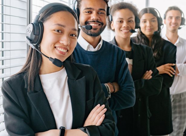 A group of people standing in a line wearing headphones for Business Phone Systems